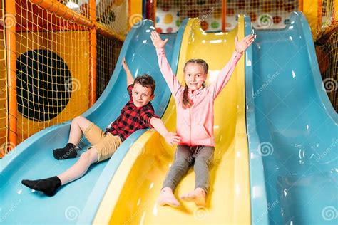 Kids Riding From Childrens Slides In Game Center Stock Image Image Of