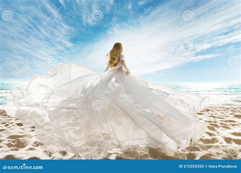 Woman On Beach In White Dress Flying On Wind Summer Vacation Beach Sand Sea Sunshine Sky Stock