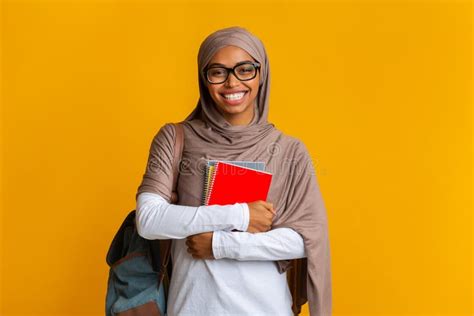 Feliz Estudante De Mu Ulmana Negra No Hijab Com Mochila E Cadernos Foto