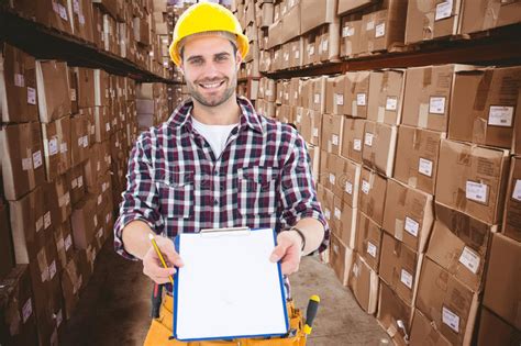 Composite Image Of Happy Male Repairman Showing Clipboard Stock Photo