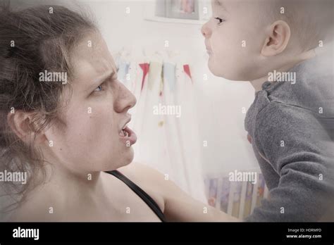 Mother Suffering From Postpartum Depression Shakes And Screams At Her Baby Stock Photo Alamy