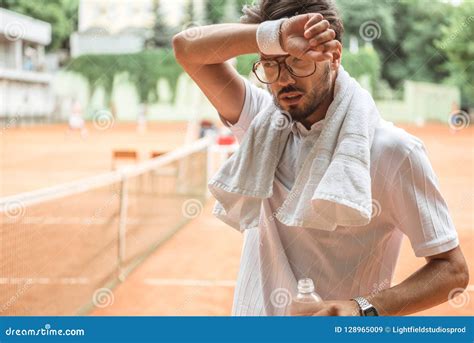 Sweaty And Tired Sportsman Karate Fighter Stands In A Fighting Stance And Looks At The Camera