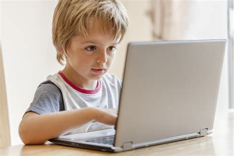 Young Boy Working On Laptop Computer Concept For Education Lear