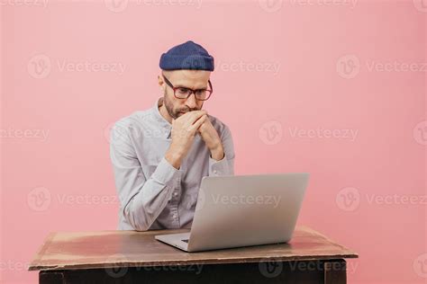 Horizontal Shot Of Concentrated Male Worker Reads Statistics