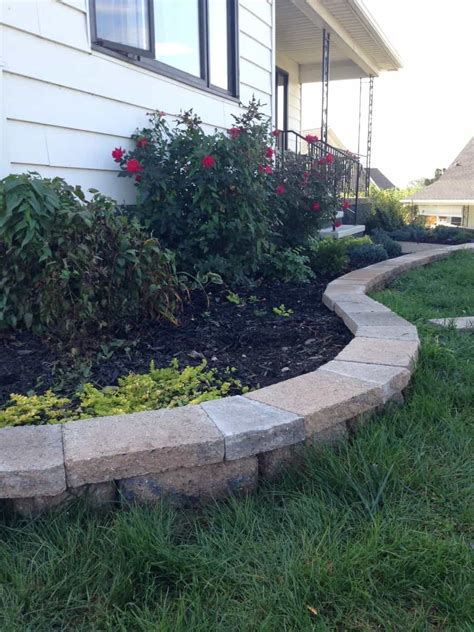The small garden stone rock border makes a world of difference when stepping out to take in the view. Cut Stone Caps for a Curved Retaining Wall | Pretty Purple ...