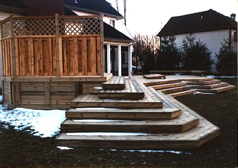 Wood Deck With Good Neighbor Privacy Fence And Cascading Stairs By