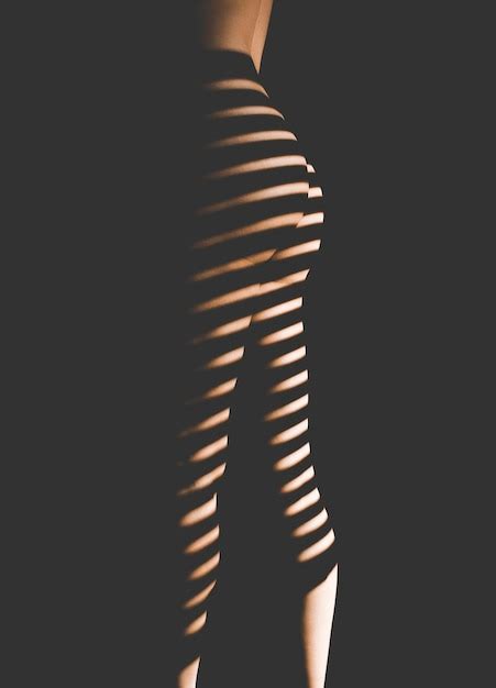 Premium Photo Midsection Of Naked Woman Standing Against Black Background