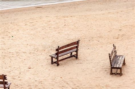 Two Wooden Benches Stand On The Beach With Sand Stock Image Image Of