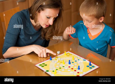 Mother And Son Playing Ludo Game At Home Stock Photo Alamy