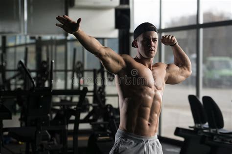 Muscular Man Flexing Muscles In Gym Stock Photo Image Of Build