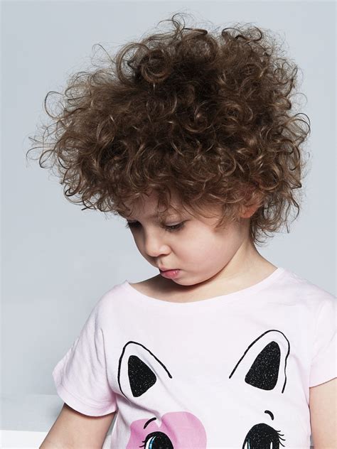 Permed hair with defined forehead and carvings side hair. Childrens' haircut to take care of large curls