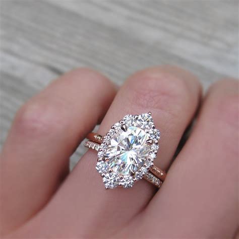 2.5 carat oval halo engagement ring paired with a conflict-free pavé