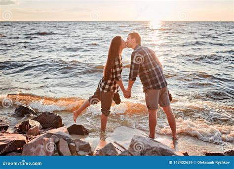 couple of lovers kissing into water at sunset stock image image of outside caucasian 143432659