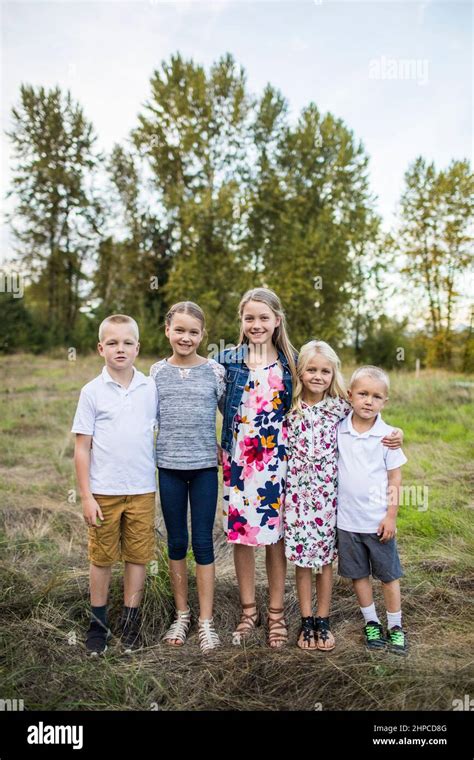 Outdoor Portrait Of Five Siblings Two Boys Three Girls Stock Photo