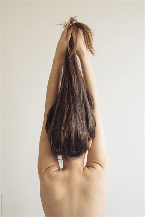 Conceptual Poses Of Woman With Long Hair By Stocksy Contributor