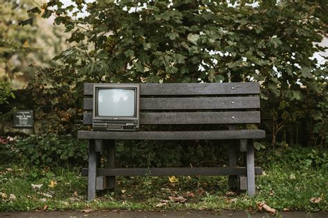 Old Tv Set On Bench In Nature · Free Stock Photo