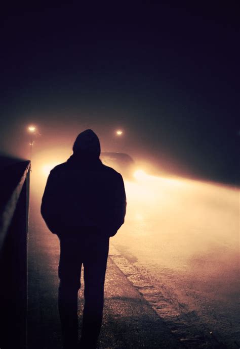 Silhouette Of A Man Walking Down The Street On A Foggy Night Dark