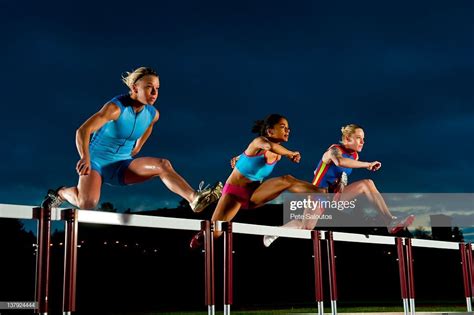 Stock Photo Runners Jumping Hurdles In Race Sport Portraits