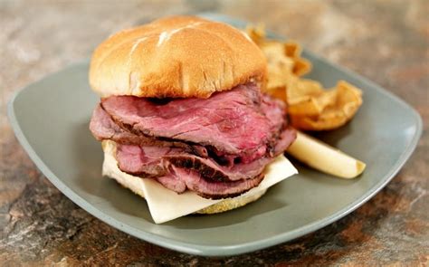 Deli Sliced Rare Roast Beef On Bulkie Roll Sandwich With American