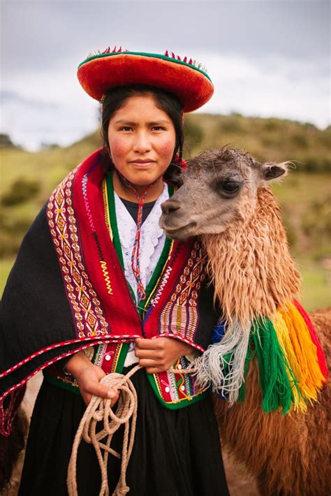 Peruvian Woman In Traditional Clothes With A Llama Travel In The