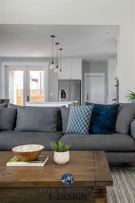 Explore our gallery of living room color inspiration. Living room with gray sectional, Stonington Gray paint ...