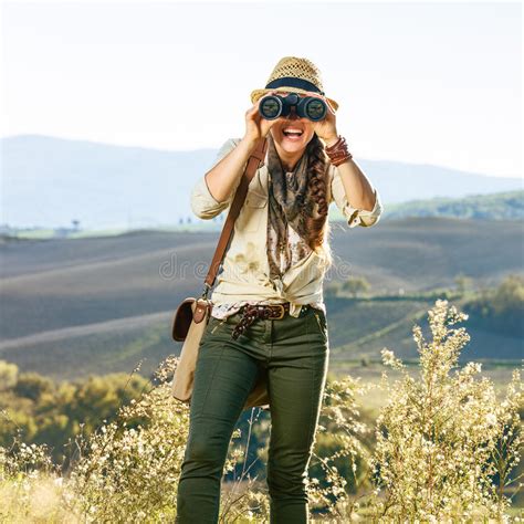 Woman Hiker In Tuscany Looking In Camera Through Binoculars Stock Image