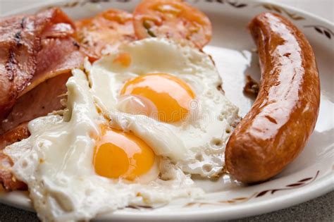 Remove from oven and move the bacon and sausages around, making 4 empty spaces for the eggs. Bacon Egg Sausage Breakfast Stock Photo - Image of plate, diet: 6524152