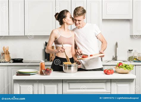 Girlfriend Kissing Boyfriend While Cooking Pasta Stock Image Image Of