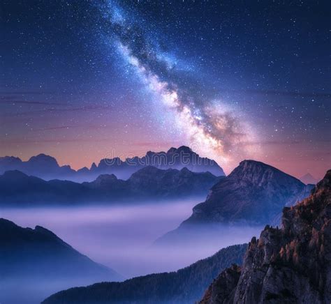 Milky Way Over Mountains In Fog At Night In Summer Stock Photo Image
