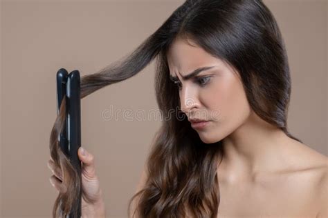 Woman With Frowned Eyebrows Looking At Flat Iron Stock Photo Image Of