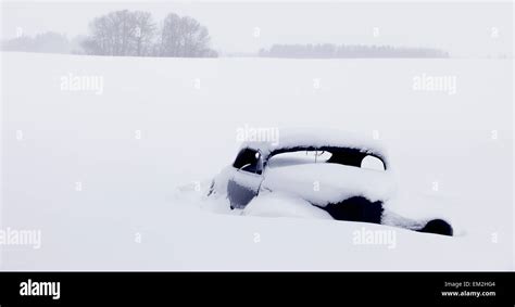 An Old Car Buried In Snow In A Field Parkland County Alberta Canada
