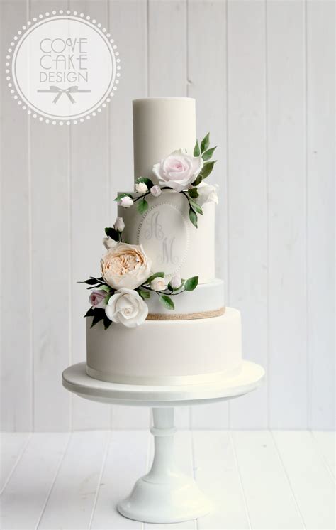 contemporary wedding cake with custom monogram and sugar flower wreath luxury wedding cake