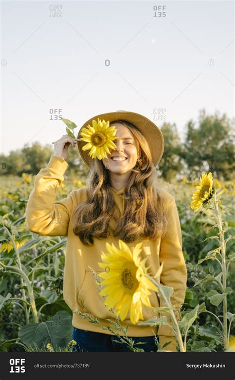 Portrait Of A Beautiful Young Woman Holding A Sunflower Stock Image