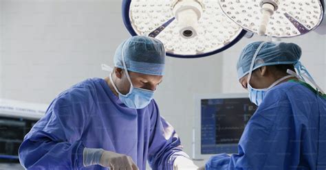 Two Surgeons Performing Surgery On A Patient In A Hospital Photo Emergency Room Image On Unsplash
