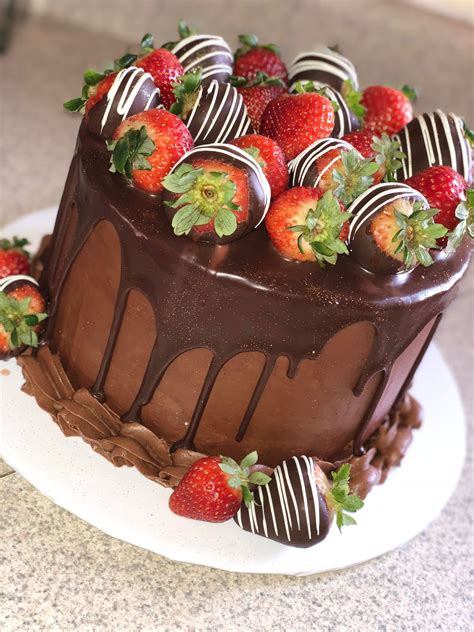 A Chocolate Covered Cake With Strawberries On Top