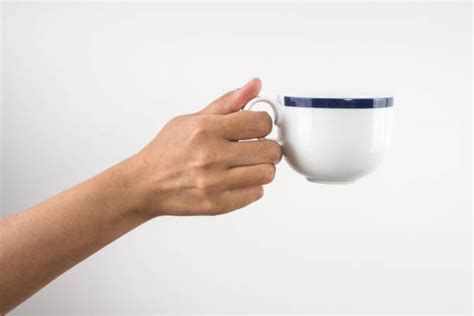 Hands Holding Tea Cups And Coffee Mugs Stock Photos Pictures And Royalty