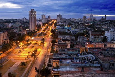 50's cars, vibrant colors, various types of architecture, lots of windows, courtyards, covered exterior hallways, women smoking cigars in the street Cuban-Themed Party Ideas | Synonym