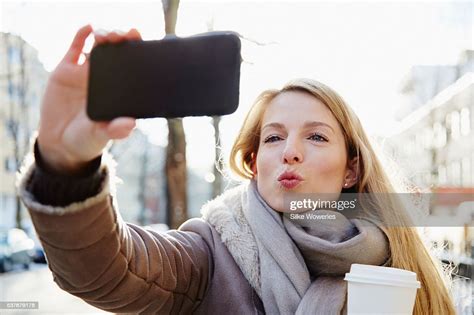 Portrait Of A Content Adult Woman Taking A Selfportrait With Her