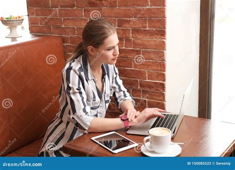 Young Freelancer With Laptop Working In Cafe Stock Photo Image Of