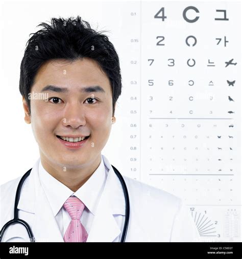 Portrait Of Eye Doctor Standing By Eye Chart Stock Photo Alamy