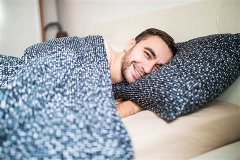 Young Handsome Happy Man Waking Up On Bed At Home Stock Photo Image
