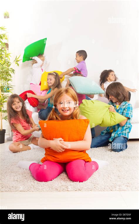Happy Smiling Little Girl Hugging Pillow With Large Group Of Her
