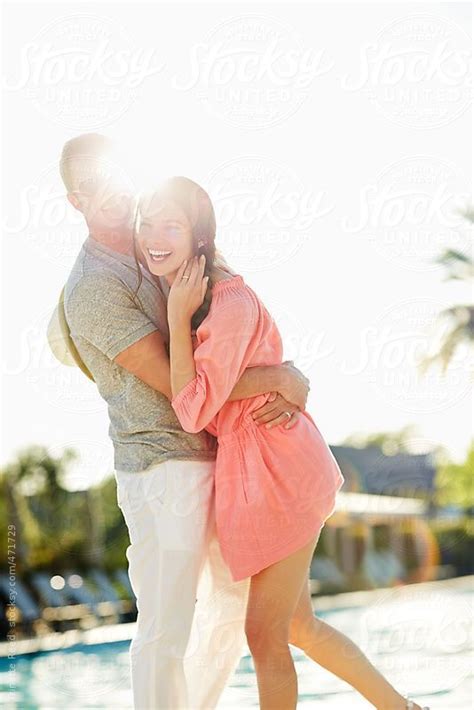 Beautiful Couple Relaxing And Having Fun By Pool At Luxury Resort By Stocksy Contributor