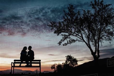 Back View Silhouettes Of Affectionate Couple Enjoying Romantic Date