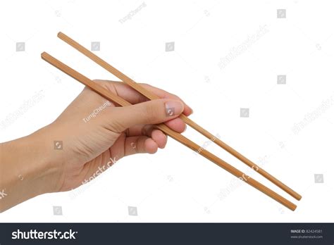 Chopsticks is a hand game for two or more players, in which players extend a number of fingers from each hand and transfer those scores by taking turns to tap one hand against another. Using Bamboo Chopsticks With Left Hand Against White Background Stock Photo 82424581 : Shutterstock