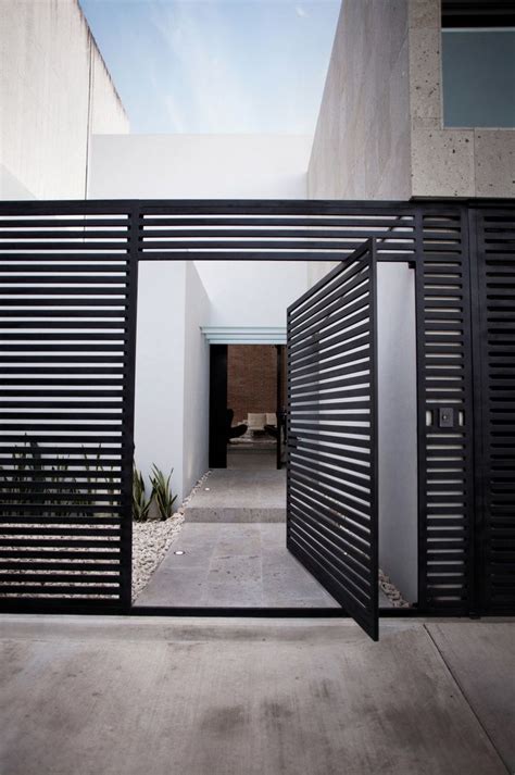 Modern style iron gate handle design. 40 Modern Entrances Designed To Impress! - Architecture Beast
