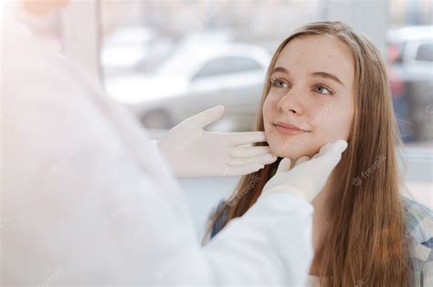 Premium Photo Delighted Smiling Cute Girl Sitting In The Clinic And Expressing Positivity