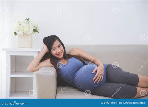 Beautiful Asian Pregnant Woman Laying On A Couch Stock Photography CartoonDealer Com