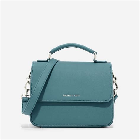 Gorgeous charles & keith black double cross bag twin vinyl and leather look. CHARLES & KEITH - Bags. Teal top handle sling bag ...