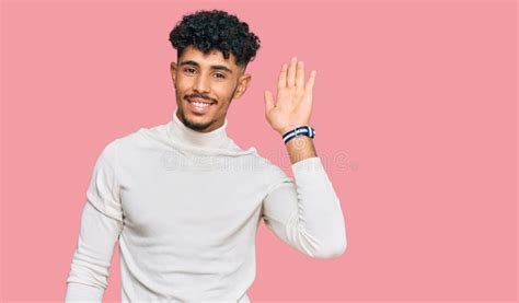 Young Arab Man Wearing Casual Winter Sweater Waiving Saying Hello Happy